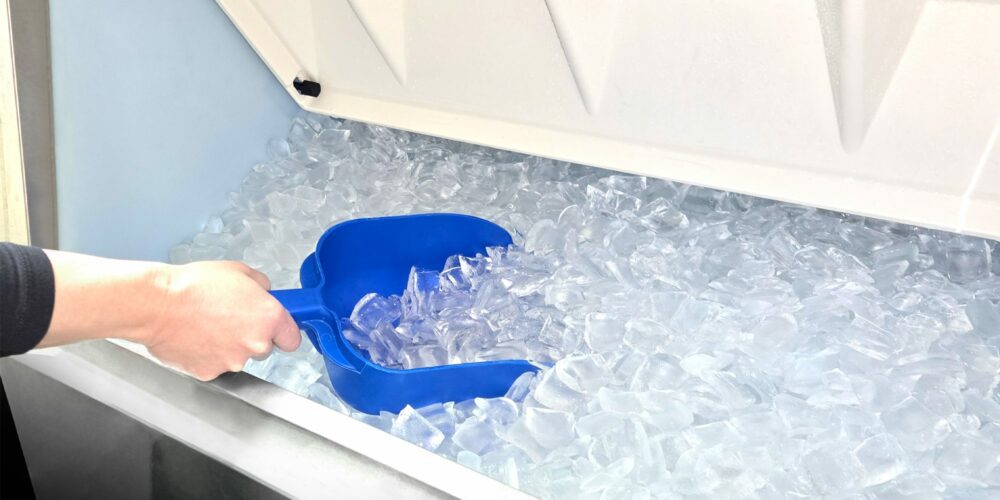 Hand getting crescent ice from a Hoshizaki Ice Bin