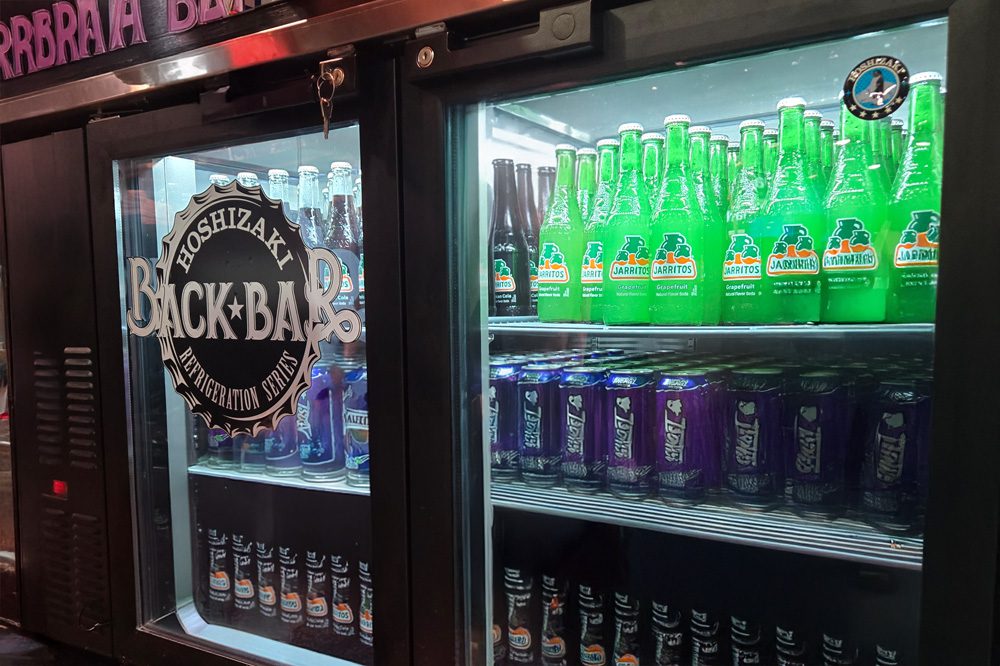 Back bar refrigerator stocked with beverages, showcasing Hoshizaki’s cooling performance and interior LED lighting.