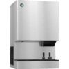 A stainless steel commercial ice and water dispenser with labeled buttons and a chute for dispensing.