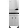 A stainless steel commercial ice and water dispenser with a top dispensing unit, two control buttons, and a lower cabinet on adjustable legs.