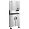 Stainless steel commercial ice and water dispenser with a top dispensing unit and lower storage cabinet, standing on four black legs.