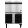 Commercial stainless steel ice maker with front-facing vents and a label that reads "Clean Air Filter Twice a Month," standing on four legs.