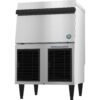 A commercial stainless steel ice maker with a top door and two black vent panels at the bottom, standing on four legs.