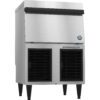Commercial stainless steel ice maker machine with front air vents, elevated on black legs, and a closed top compartment.