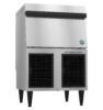 Commercial stainless steel ice maker machine with front air vents, elevated on black legs, and a closed top compartment.