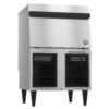 Stainless steel commercial ice maker with front air vents, black legs, and a top-loading ice compartment.