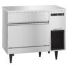 Commercial stainless steel undercounter ice maker with digital display, vent, and two storage drawers, standing on four black legs.