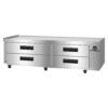 Stainless steel commercial refrigerated chef base with four pull-out drawers, black handles, and digital temperature display on the right side, set on wheels.