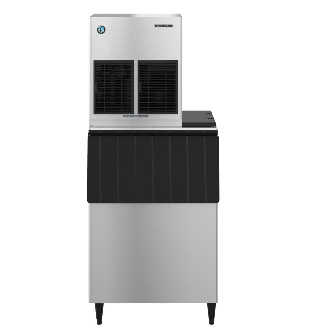 A commercial stainless steel ice maker machine with a vented front panel, black trim, and four legs, photographed against a plain white background.