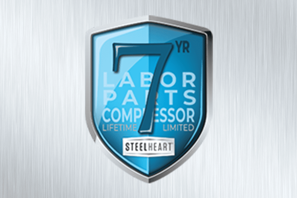 A blue and silver shield badge displaying "7 Yr Labor Parts Compressor Lifetime Limited Steelheart" on a brushed metal background.