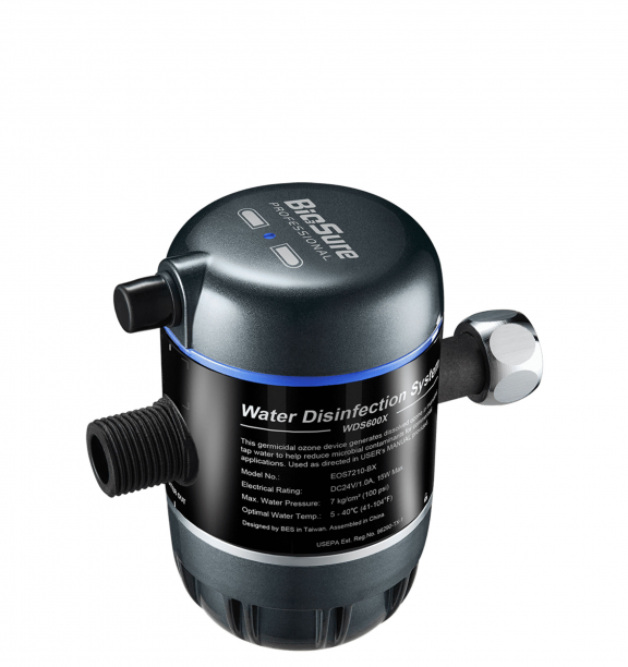 A compact water disinfection device with labeled instructions and connectors for inlet and outlet pipes, designed for ozone-based germicidal treatment.