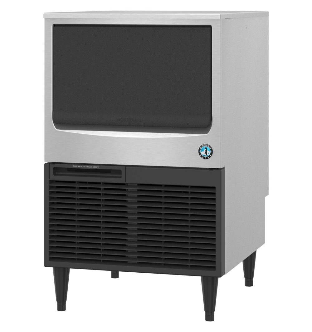 A stainless steel commercial ice maker with a black front panel, vent, and four legs, standing on a white background.