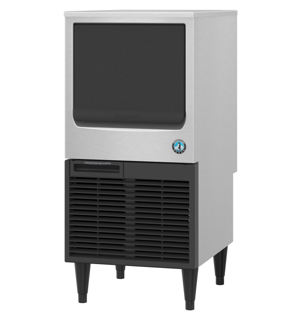 A commercial ice maker machine with a stainless steel body, front air vents, and four black legs.
