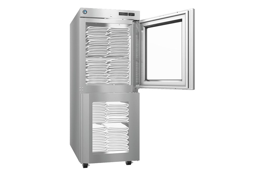 A stainless steel cabinet with two compartments, both filled with neatly stacked folded towels; the upper door is open, showing the contents inside.