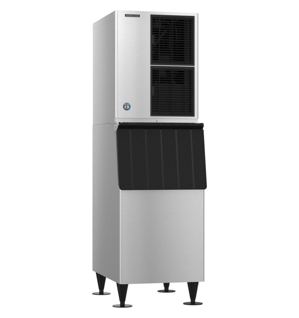A commercial stainless steel ice maker machine with a black front panel, raised on four legs.
