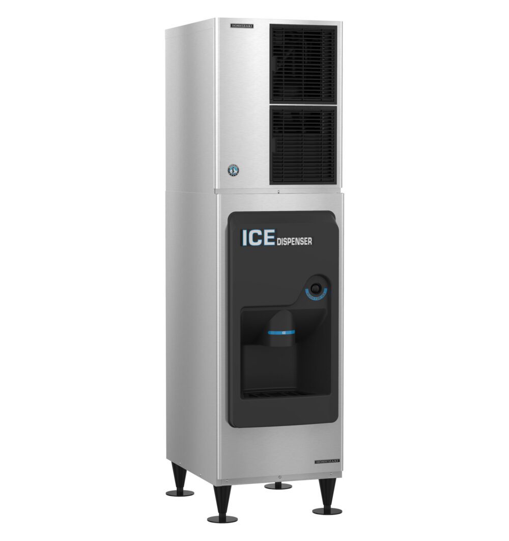 A stainless steel commercial ice dispenser with a black dispensing area and visible cup under the ice chute, standing on four legs.