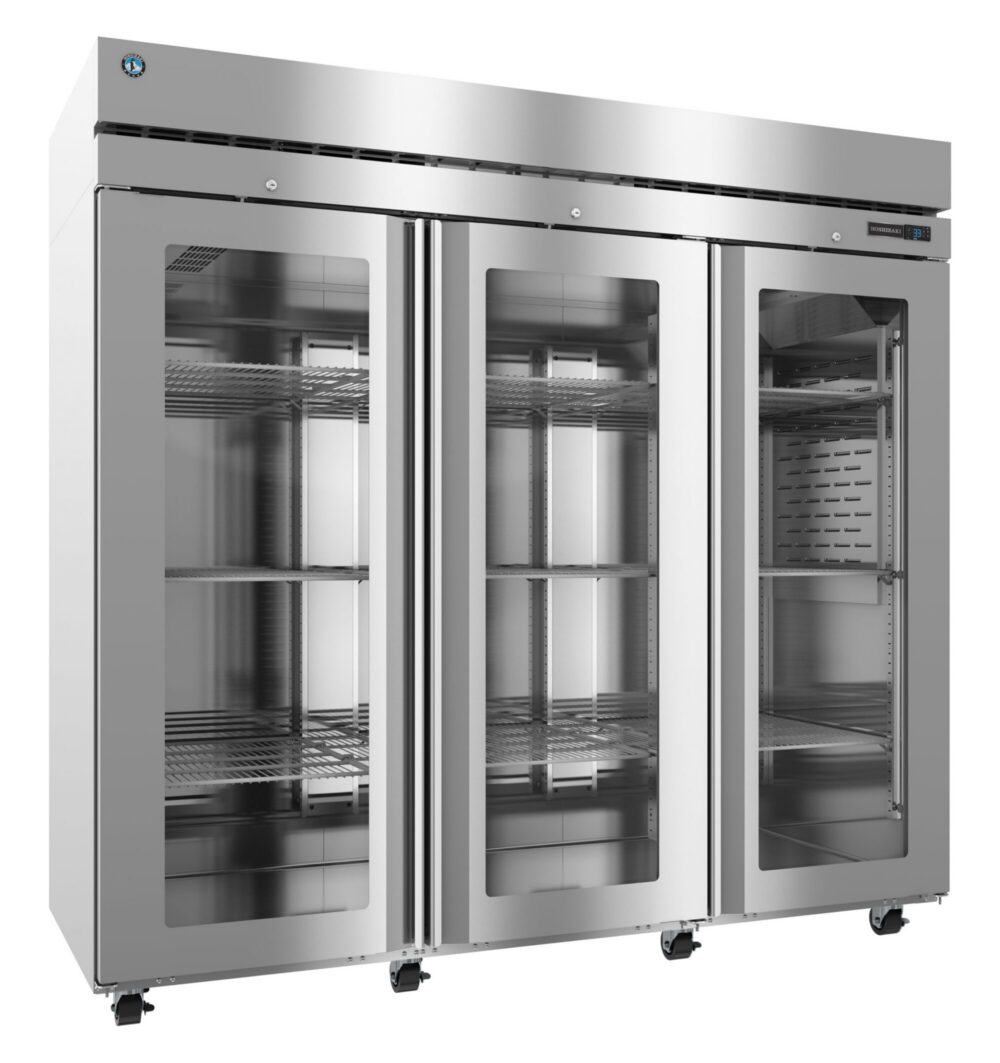 Large stainless steel commercial refrigerator with three glass doors, interior shelving, and mounted on wheels.