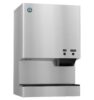 A stainless steel wall-mounted ice and water dispenser with labeled buttons for ice and water on the front panel.