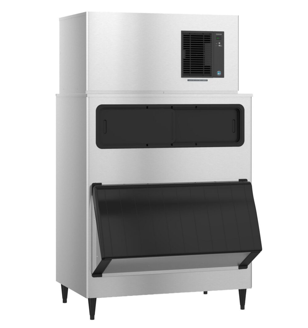 Large commercial stainless steel ice maker with a top cooling vent and a black front-access door on the storage bin, standing on four legs.