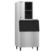 A commercial stainless steel ice machine with a top ice maker unit and a bottom storage bin, standing on four legs.