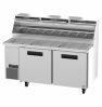 A stainless steel commercial refrigerator prep table with double doors, a prep rail with ingredient containers, and a top shelf for additional storage.