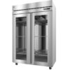 A commercial stainless steel, double-door refrigerator with glass doors, interior shelves, and caster wheels, viewed at a slight angle.