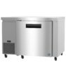 Stainless steel commercial undercounter refrigerator with a digital temperature display and caster wheels.