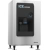 Stainless steel commercial ice dispenser with a black front panel, ice chute, push button, and dispenser spout, standing on adjustable legs.