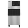 Commercial stainless steel ice machine with black panel and vents on the top, standing on four legs, photographed against a white background.